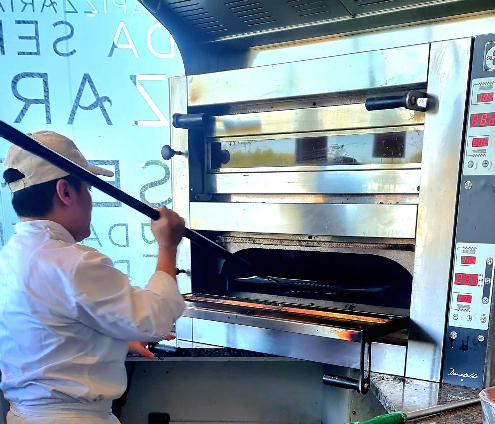 Monchique Resort & Spa エクステリア 写真 A pizzaiolo baking a pizza in a wood-fired oven
